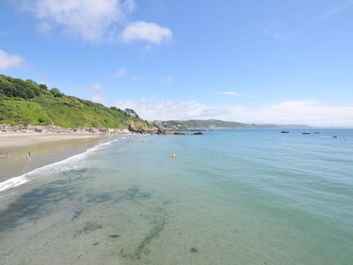 a view of a beach with people in the water at Evelyn in Looe
