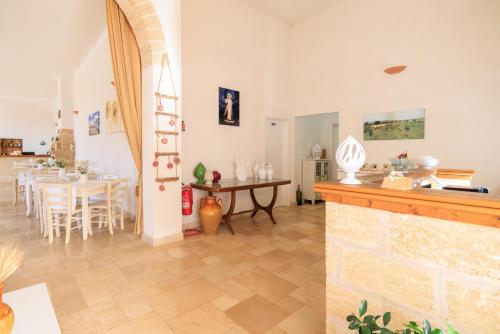 a living room with a table and a dining room at Masseria Il Vignale in Ostuni