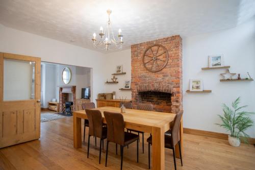 a dining room with a table and a fireplace at Cosy City Home from home! in Portsmouth