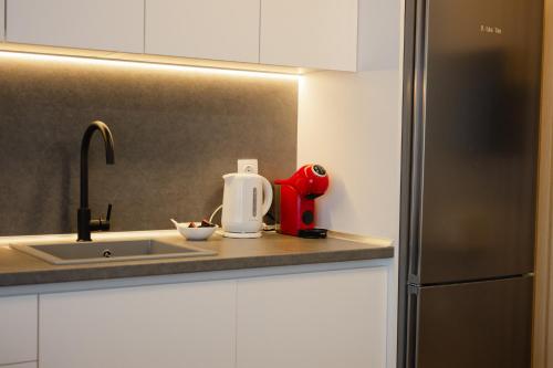 a kitchen with a sink and a refrigerator at Tower Luxury Flats in Alexandroupoli