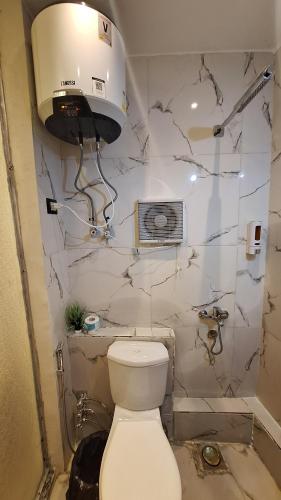 a bathroom with a toilet and a sink at Grand Duplex in Aswan