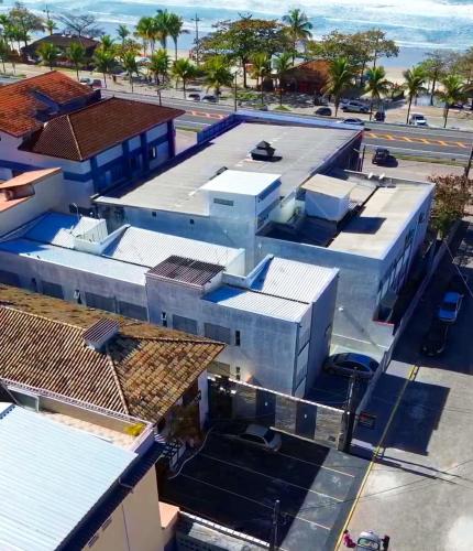 an aerial view of a building with the ocean in the background at Pousada Vison Ubatuba - Praia Grande in Ubatuba