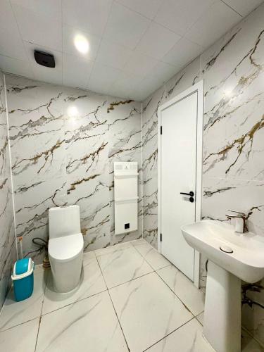a bathroom with a toilet and a sink at Cozy year-round cottage near UB with additional pick-up service from the Airport in Dzuunmod