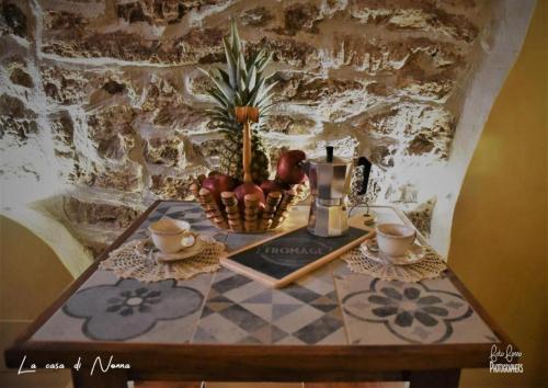 a table with a basket of fruit on it at La Casa di Nonna in Tivoli