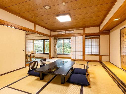 a dining room with a table and chairs at Yoshiike Ryokan in Hakone