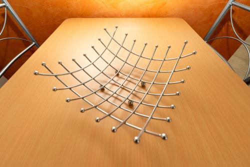 a wooden table with a bunch of spheres on it at Turin Airport apt I in Leinì