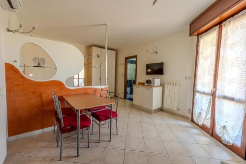 a dining room with a table and chairs at Turin Airport apt I in Leinì