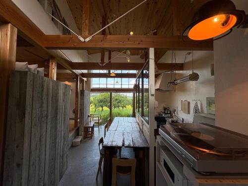 a kitchen with a wooden table in the middle of a room at hanare 6tsuki - Vacation STAY 10034v in Saikū