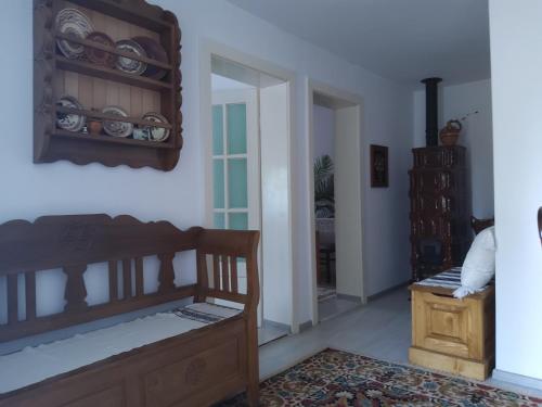 a room with a bed and a table and a mirror at Casa Cătălina in Silvaşu de Jos