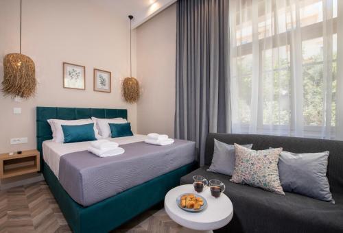 a bedroom with a bed and a couch at Alba Boutique Hotel in Chania Town