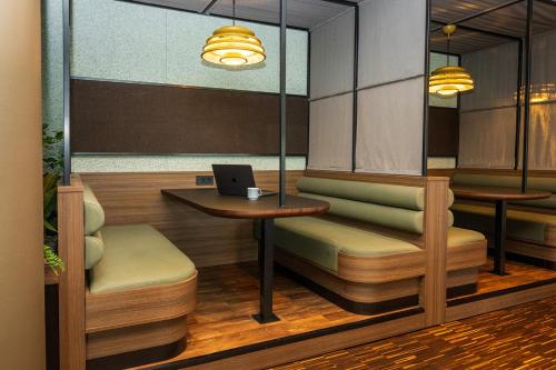 a restaurant with a table and a laptop on it at Comfort Hotel RunWay in Gardermoen