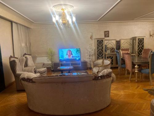 a living room with a large couch and a tv at Aqua Degla Luxury Villa 199 street Maadi Degla in Cairo