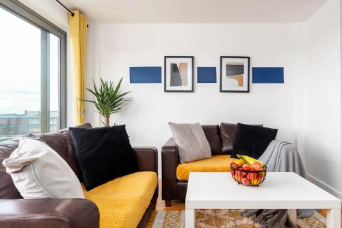 a living room with a couch and a table at Stylish 2BR Apartment near Sheffield City Centre in Sheffield