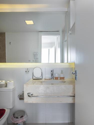 a bathroom with a sink and a mirror at Penthouse ROBELINI - Terraza, jacuzzi & vistas in Asuncion