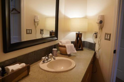 a bathroom with a sink and a mirror at Mountain View Estate Forest Hot Tub Full Arcade in Snohomish