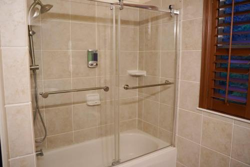 a bathroom with a shower with a glass door at Mountain View Estate Forest Hot Tub Full Arcade in Snohomish