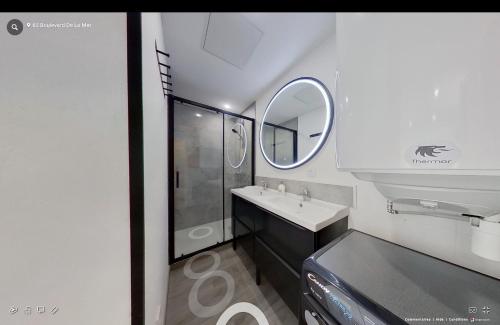 a bathroom with a sink and a mirror at Maison individuelle Aytré plage terrain clos 280m2 très calme in Aytré