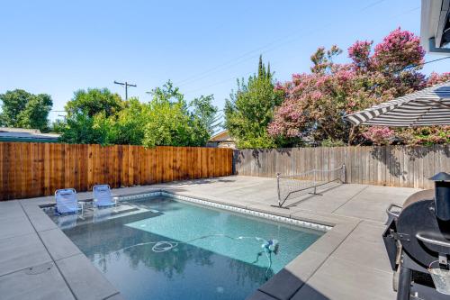 a swimming pool with two chairs and a fence at 2 Mi to Dtwn Home with Private Pool in Sacramento in West Sacramento