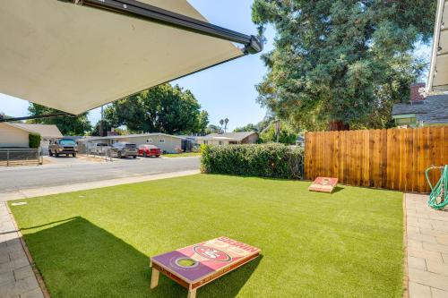 a small yard with a sign on the grass at 2 Mi to Dtwn Home with Private Pool in Sacramento in West Sacramento