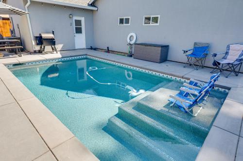 a swimming pool with a blue chair in the water at 2 Mi to Dtwn Home with Private Pool in Sacramento in West Sacramento