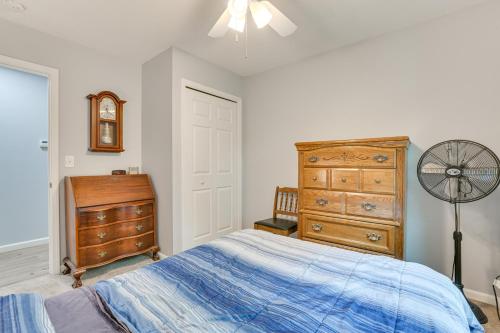 a bedroom with a bed and a dresser and a fan at Walk to Sand Lake Family-Friendly Getaway with Deck in National City