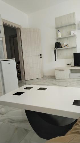 a white desk in a room with a white wall at Mara in Prokuplje
