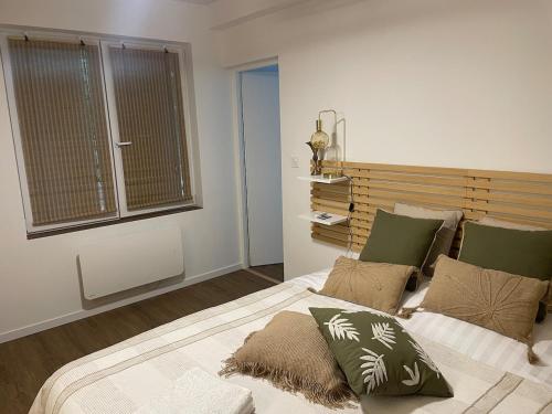 a bedroom with a large bed and a window at House in forest proche GR and circuit in Saint-Mars-la-Brière
