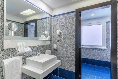 a bathroom with a sink and a mirror at Best Western Plus Hotel Universo in Rome
