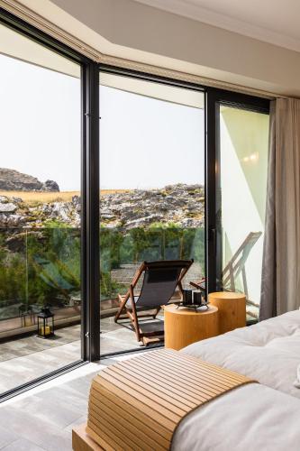 a bedroom with a bed and a large glass window at Tripiti Cozy Flat in Damnoni