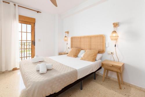 a bedroom with a large bed with towels on it at Travel Habitat Port Saplaya con vistas al Mar in Port Saplaya