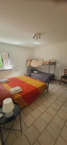 a bedroom with two bunk beds and a chair at La Casetta in Marina di Massa