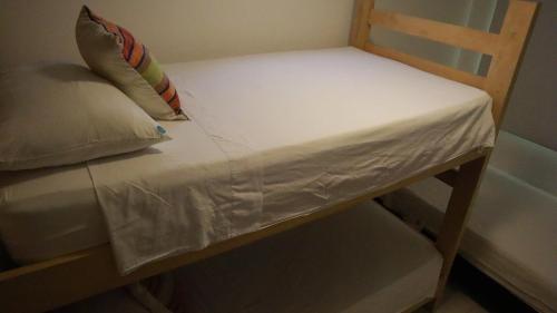 a wooden chair with a pillow on top of it at D-rio Apto in Ríohacha