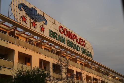 a building with a sign for a baseball ballpark at Complex Bran Brad Bega in Eforie Nord