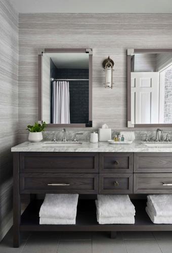 a bathroom with two sinks and a large mirror at Wequassett Resort and Golf Club in East Harwich