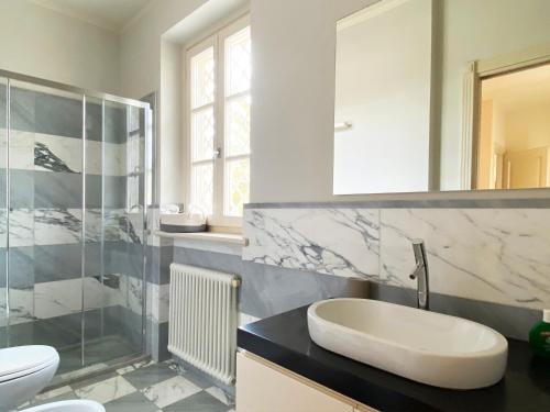 a bathroom with a sink and a shower and a toilet at Villa Ginevra - Luxury Villa in Forte dei Marmi