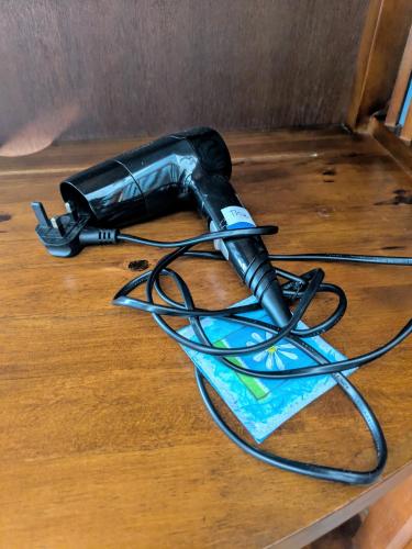 a hair dryer sitting on top of a wooden table at The Manse featuring the Daisy Camrose in Haverfordwest