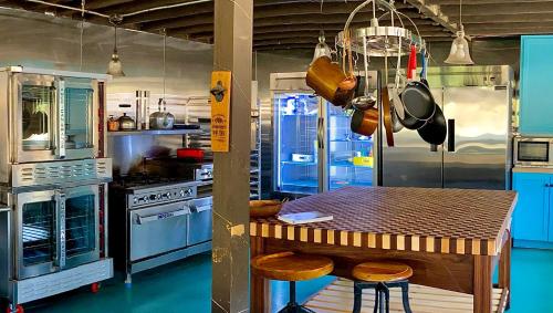 a kitchen with a table with stools and a stove at Rancho Grande in Ojai