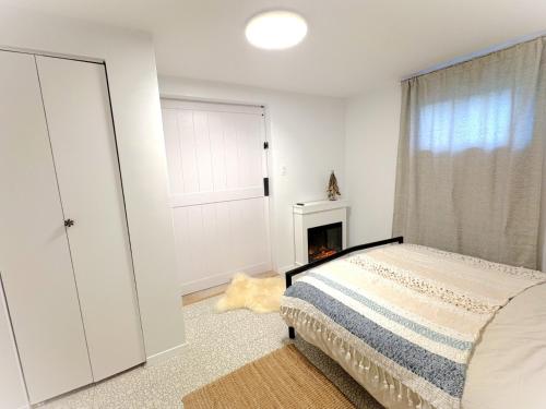 a bedroom with a bed and a window and a fireplace at Montreal - Laval Haven - Entire Rental Unit in Laval