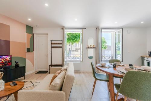 a living room with a couch and a table at Le Nid Urbain - Center - Ground floor in Meaux