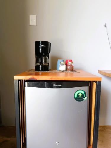 a small refrigerator with a coffee maker on top of it at El Turix Bacalar in Bacalar