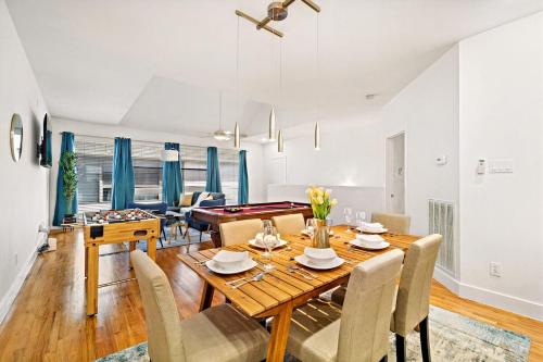 a dining room and living room with a table and chairs at Houston Getaway by Downtown Pool Table Pets in Houston