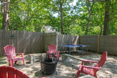a picnic table and chairs in a backyard with a fence at Sunroom Expansive Patio Fenced Yard in Eastham