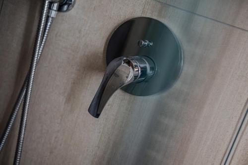 a shower door with a water bottle sticking out at Paverno Suites in Marano di Valpolicella