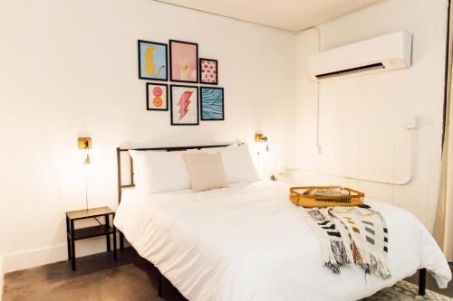 a bedroom with a large white bed with a table on it at ~The Abigail~ Rooftop / Skyline / Cozy in Atlanta