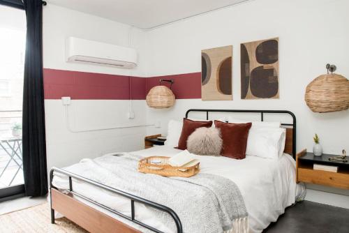 a bedroom with a bed with a book on it at *NEW* The Scarlet - Downtown | Balcony | Skyline in Atlanta