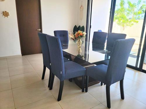 a dining room table with blue chairs and a mirror at Beautiful House Private Pool 2 min Sitpach Family 