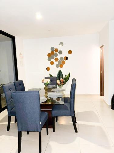 a dining room with a table and blue chairs at Beautiful House Private Pool 2 min Sitpach Family 