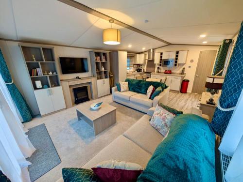 a living room with a couch and a fireplace at Whispering Pines in Great Yarmouth