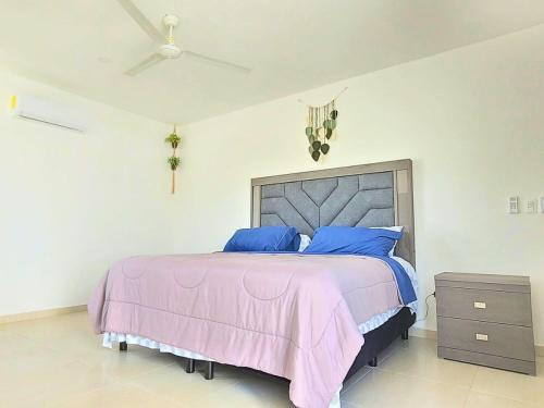 a bedroom with a large bed with blue pillows at Beautiful House Private Pool 2 min Sitpach Family 