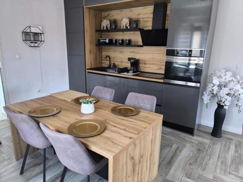 a kitchen with a wooden table and chairs at Villa S in Vir